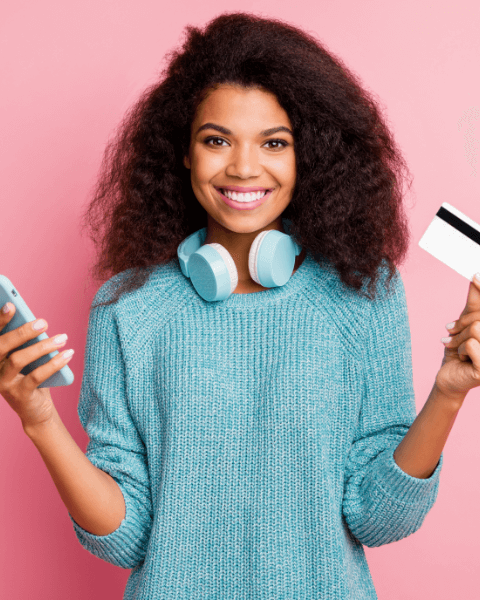 close-up-portrait-her-she-nice-attractive-lovely-cheerful-cheery-wavy-haired-girl-holding-hands-cell-bank-card-wireless-purchase-buying-shopping-online-isolated-pink-pastel-color-wall