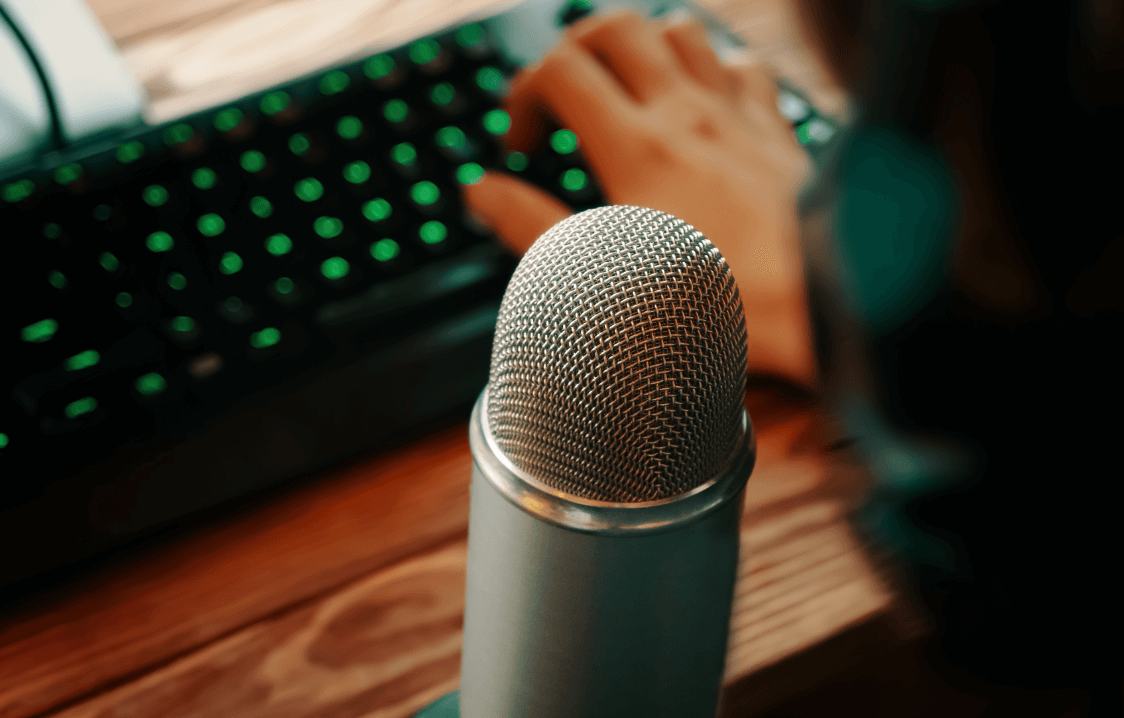 man-with-headphones-is-typing-keyboard-podcasting-with-retro-old-microphone-radio-show-audio-podcast-concept