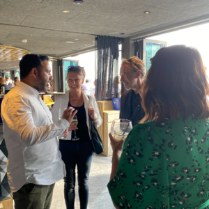 Two men and two women talking inside a bar at AdTonos' July 'AudioSushi' Event