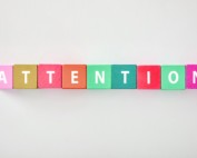Colourful wooden blocks spelling out 'attention'