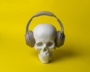 A skull wearing headphones o a yellow background