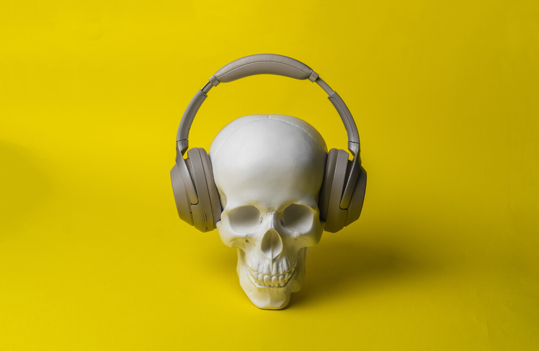 A skull wearing headphones o a yellow background