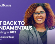 Brown woman smiling while holding a laptop next to text "Get back to fundamentals"
